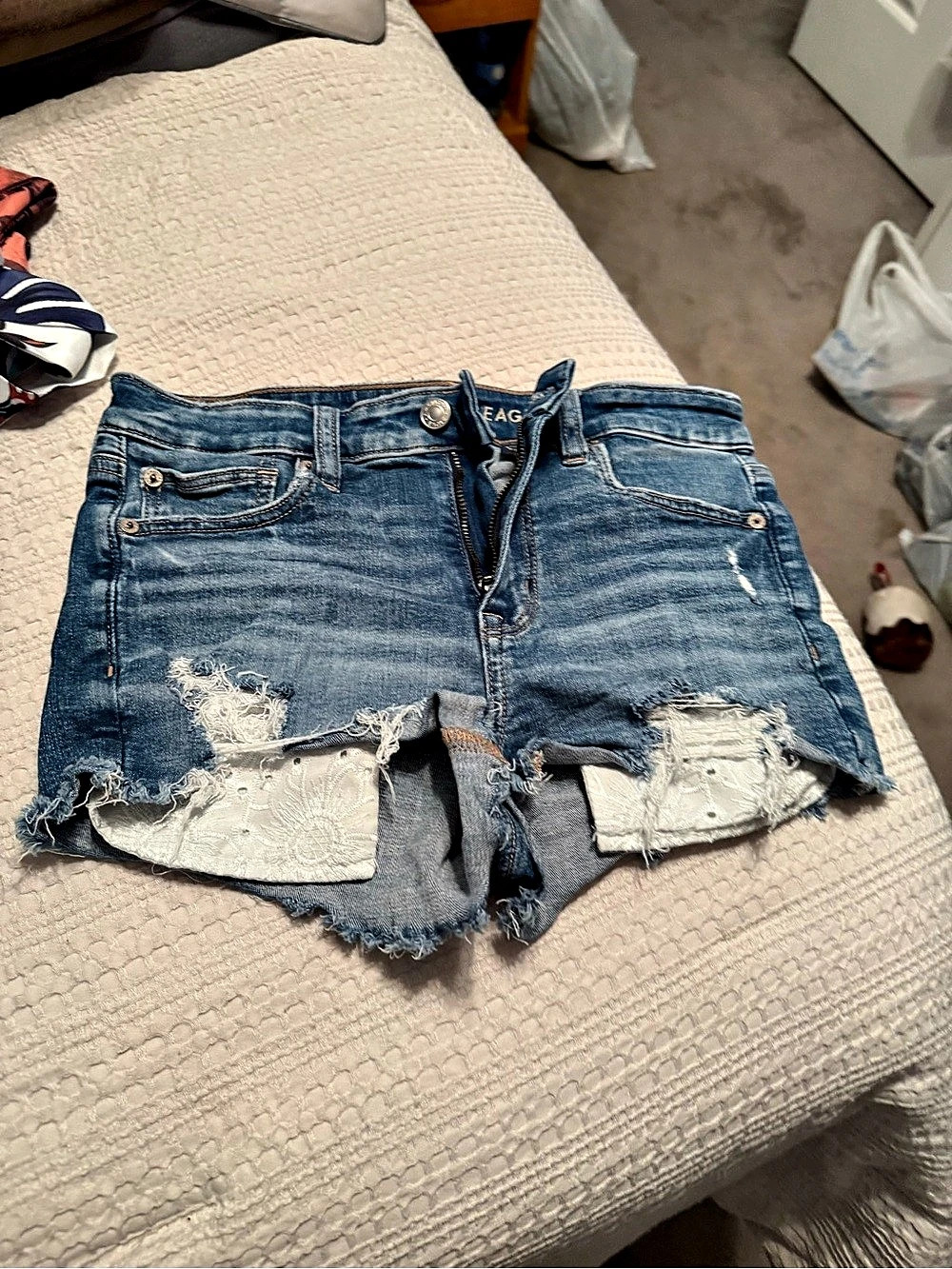 American Eagle Next Level High-Waisted Ripped Denim Shortie with Eyelet Lace
